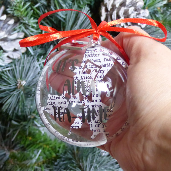 Mad hatter paper cut silhouette pouring tea text reads it's always tea-time