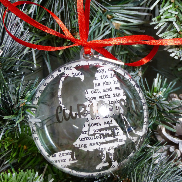 Alice in wonderland paper cut bauble text reads curiouser & curiouser