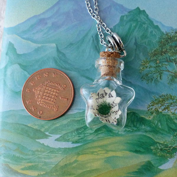 Book daisy necklace next to 1 pence piece for scale