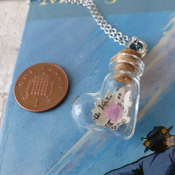 Daisy necklace next to penny for scale